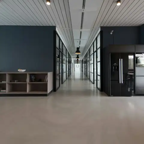 An empty office corridor with glass walls