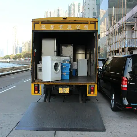 A box truck with its rear door open, loaded with appliances
