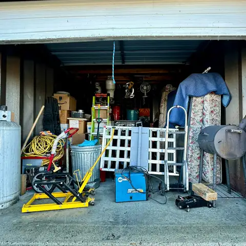 An open storage unit packed with tools and equipment