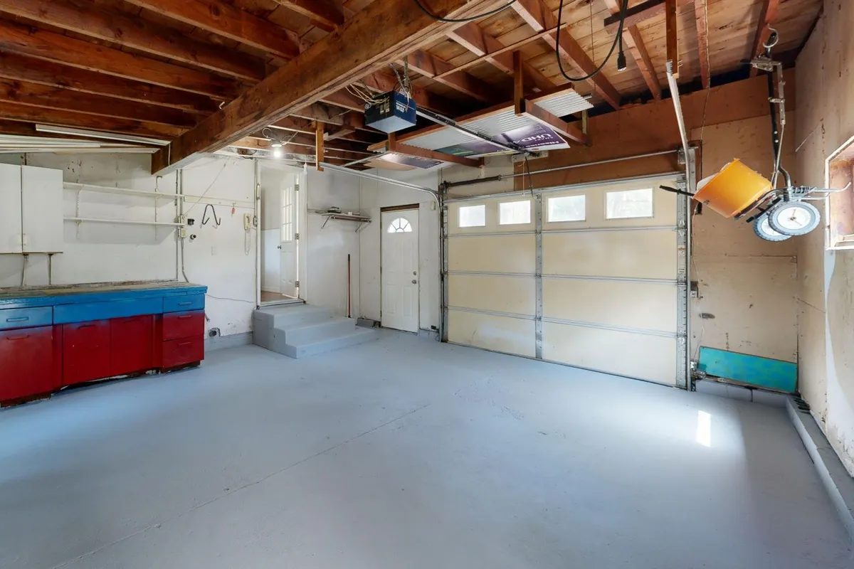 A spacious garage with colorful storage cabinets, illustrating effective clutter management strategies.